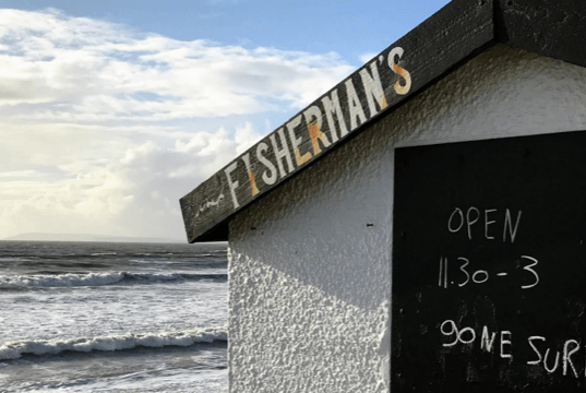 fishermans hut with a blackboard sign